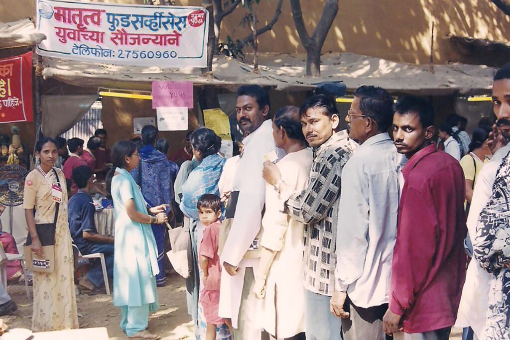 Citizens queue up for a meal prepared by Matrutva Service Cooperative - YUVA